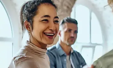 Health and Human Services Worker Smiling at Patient with Hand on Shoulder